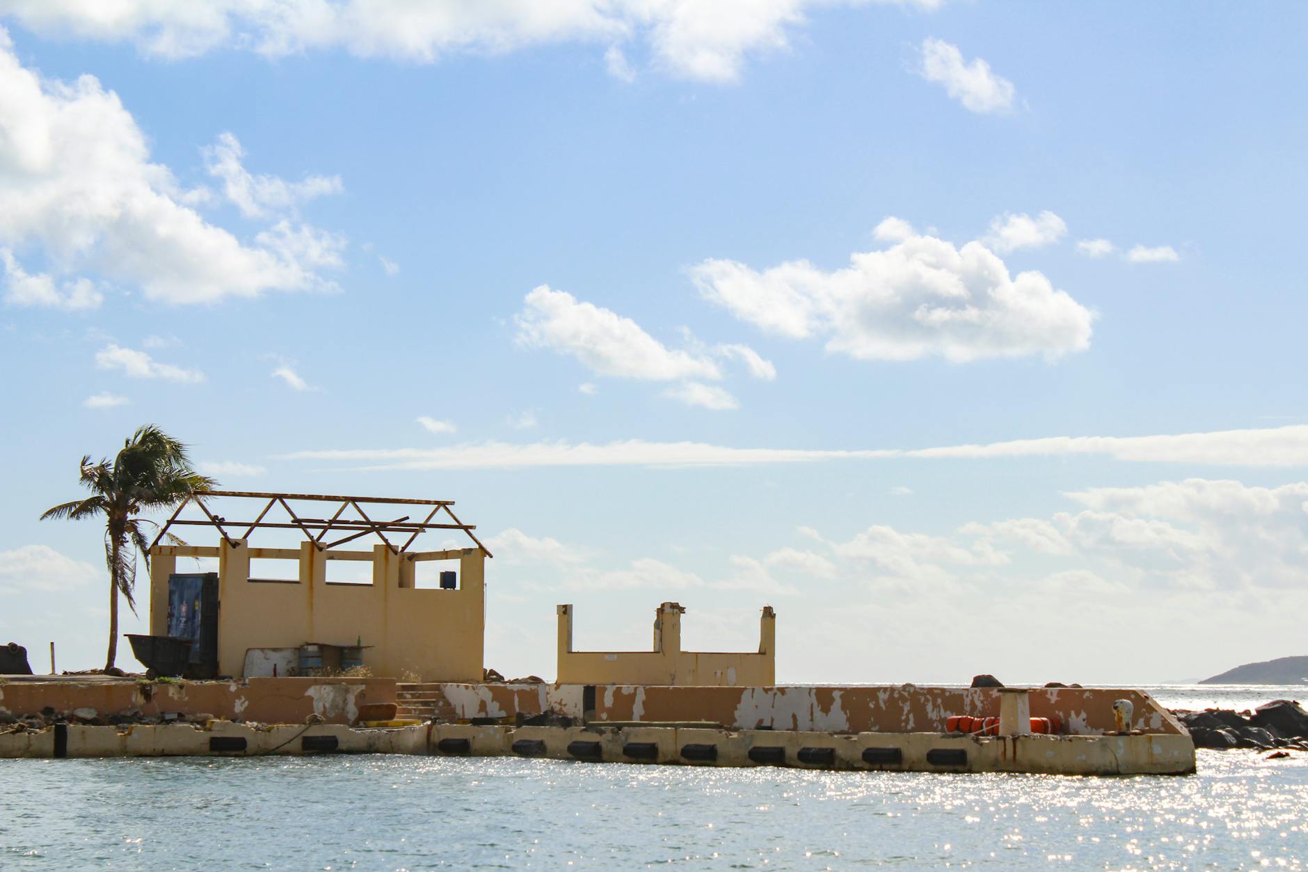 Dilapidated waterfront structure in Fajardo, Puerto Rico, post-hurricane.