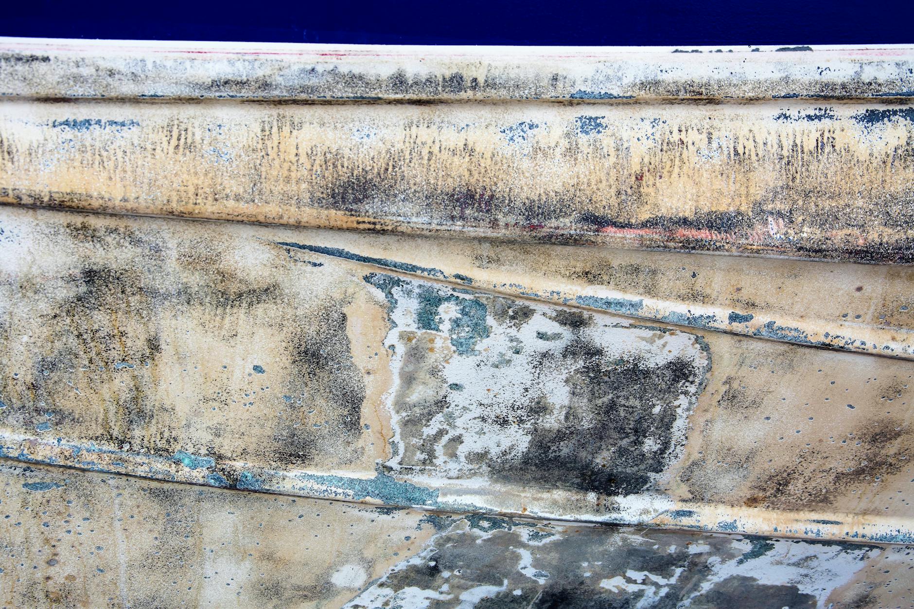 Close-up of an old boat's decaying surface with rustic textures, perfect for background use.