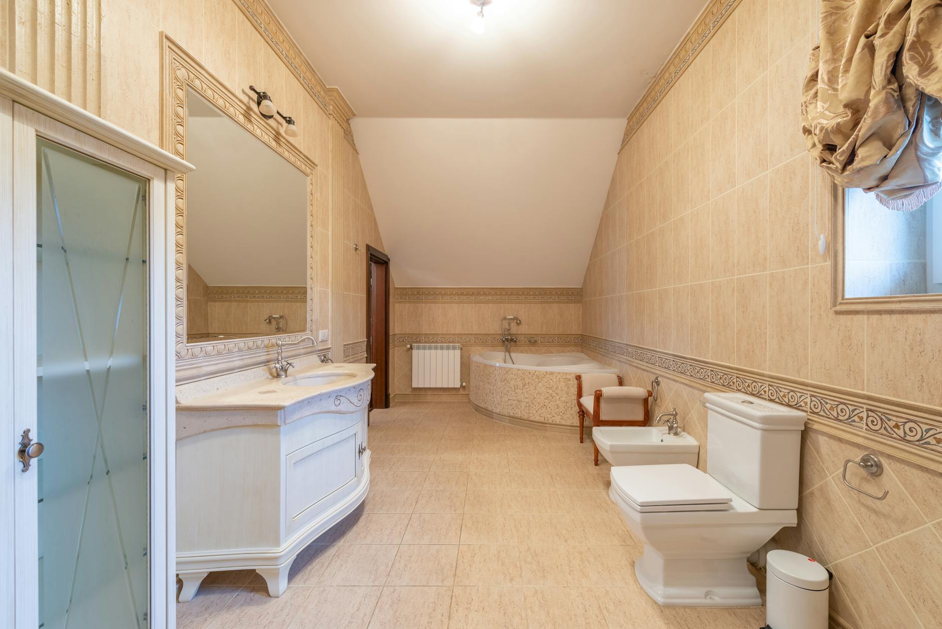 Spacious modern bathroom with contemporary design elements including a large bathtub and elegant fixtures.