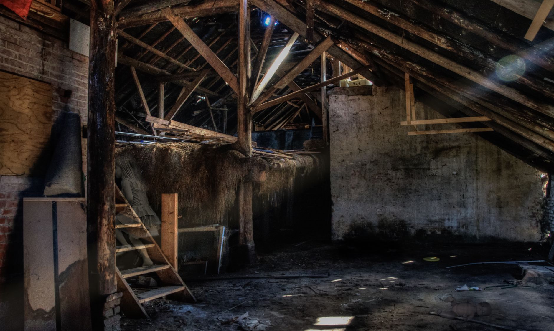 Sunlit abandoned attic showcasing rustic wooden beams and dust, creating an eerie atmosphere.