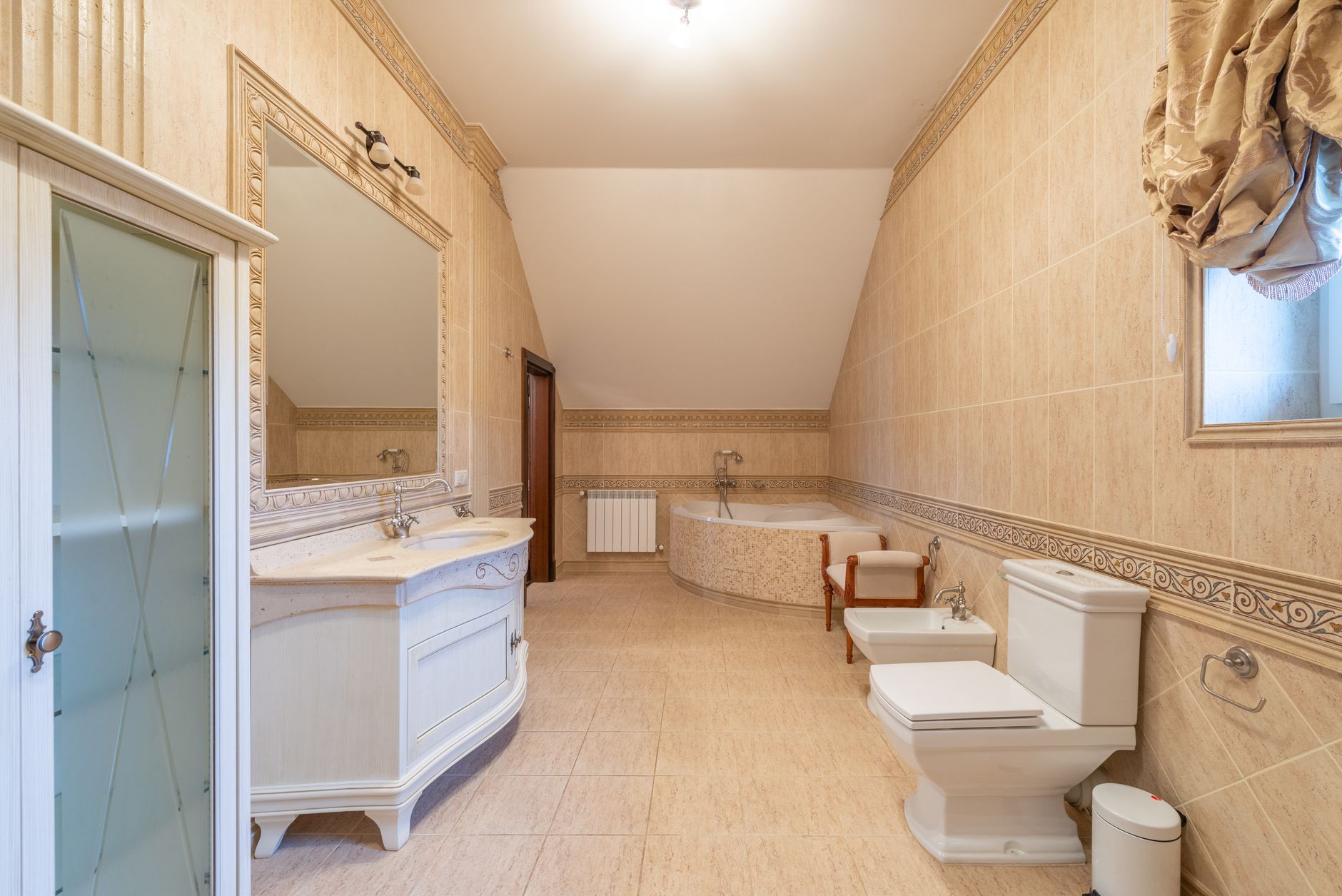 Spacious modern bathroom with contemporary design elements including a large bathtub and elegant fixtures.