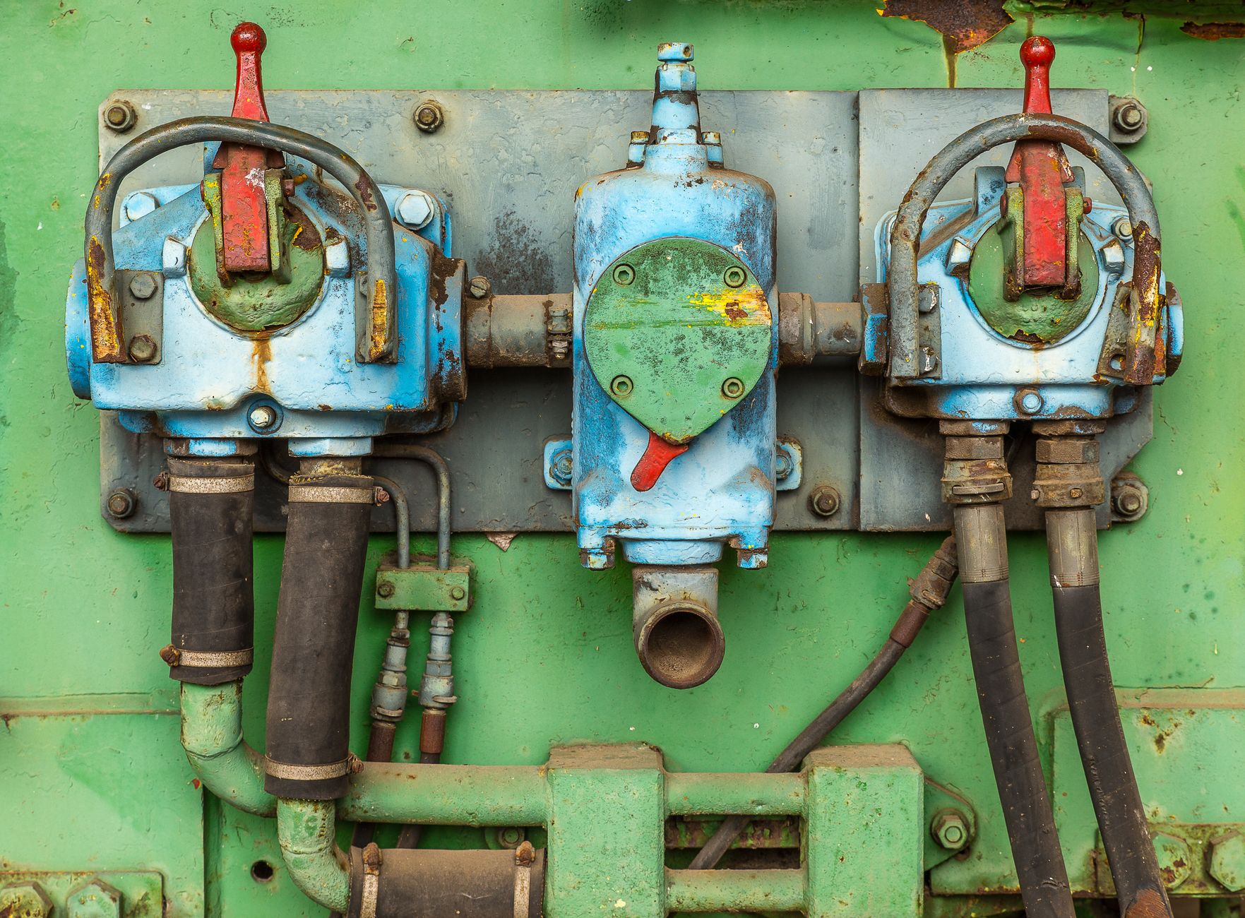 Close-up of aged and corroded industrial machinery showcasing rusty valves and pipes.