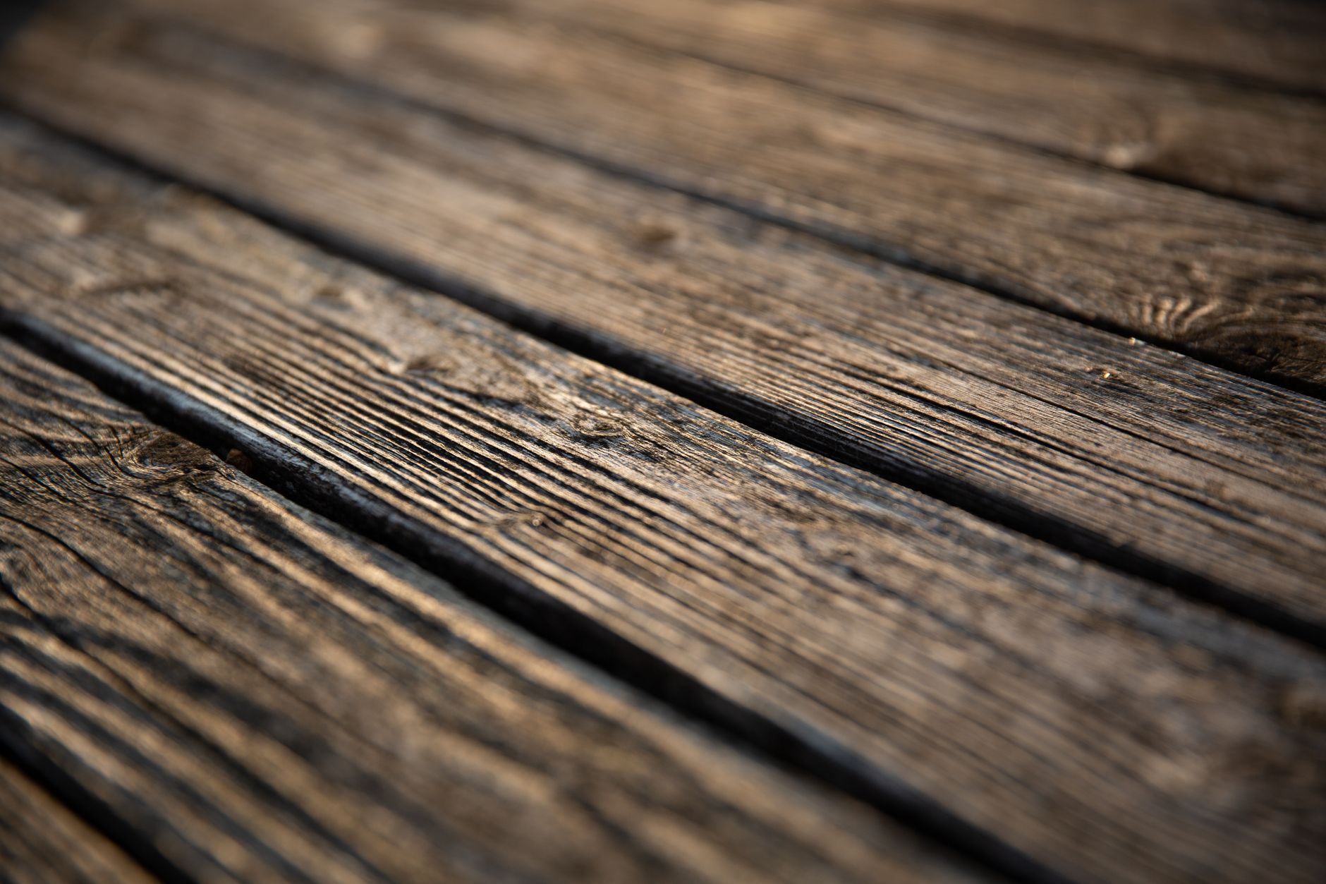 Detailed close-up image of textured, rustic wooden planks, showcasing natural patterns and grain.
