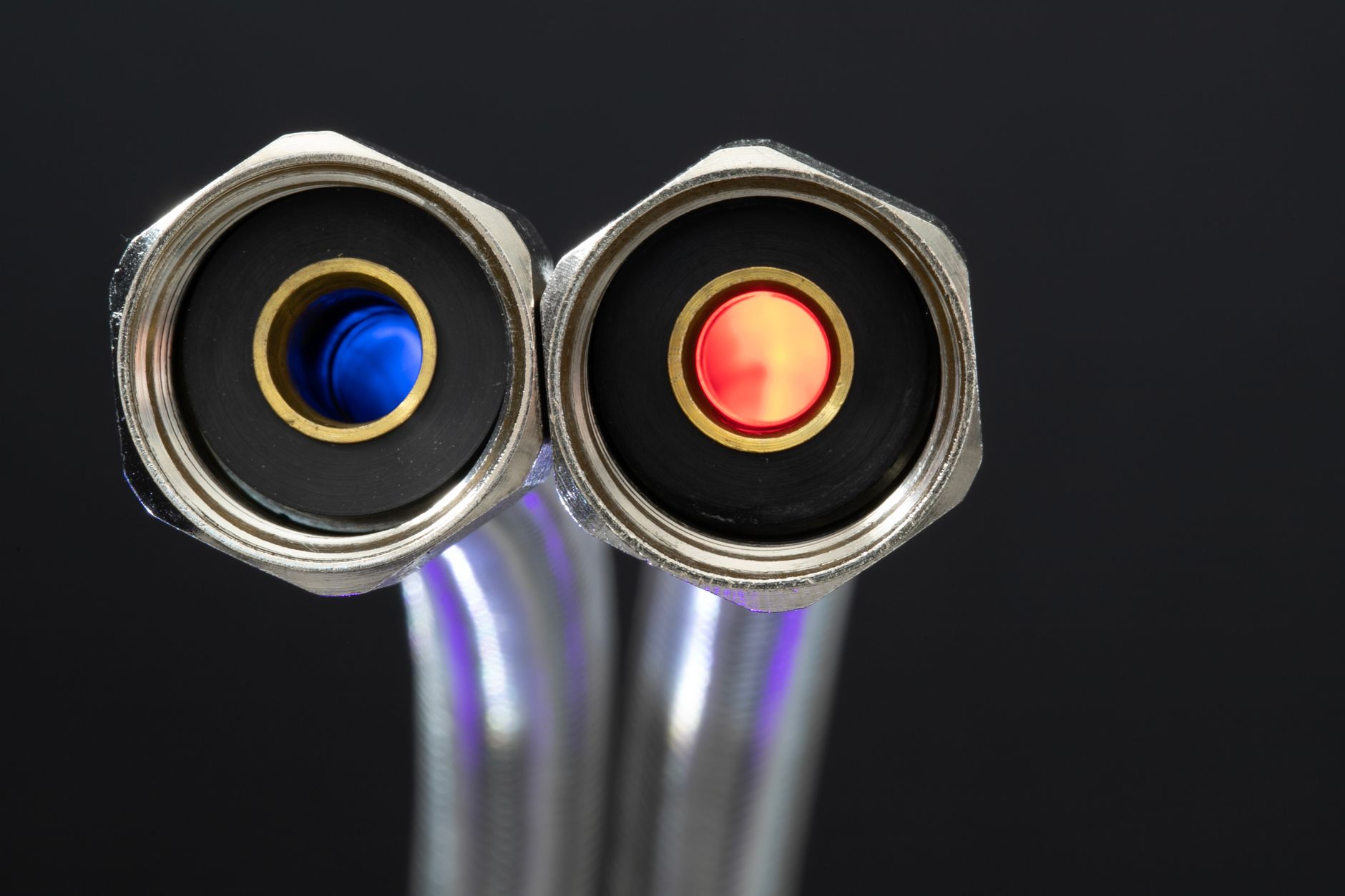 Detailed close-up of chrome metal hose connectors with red and blue color indicators.