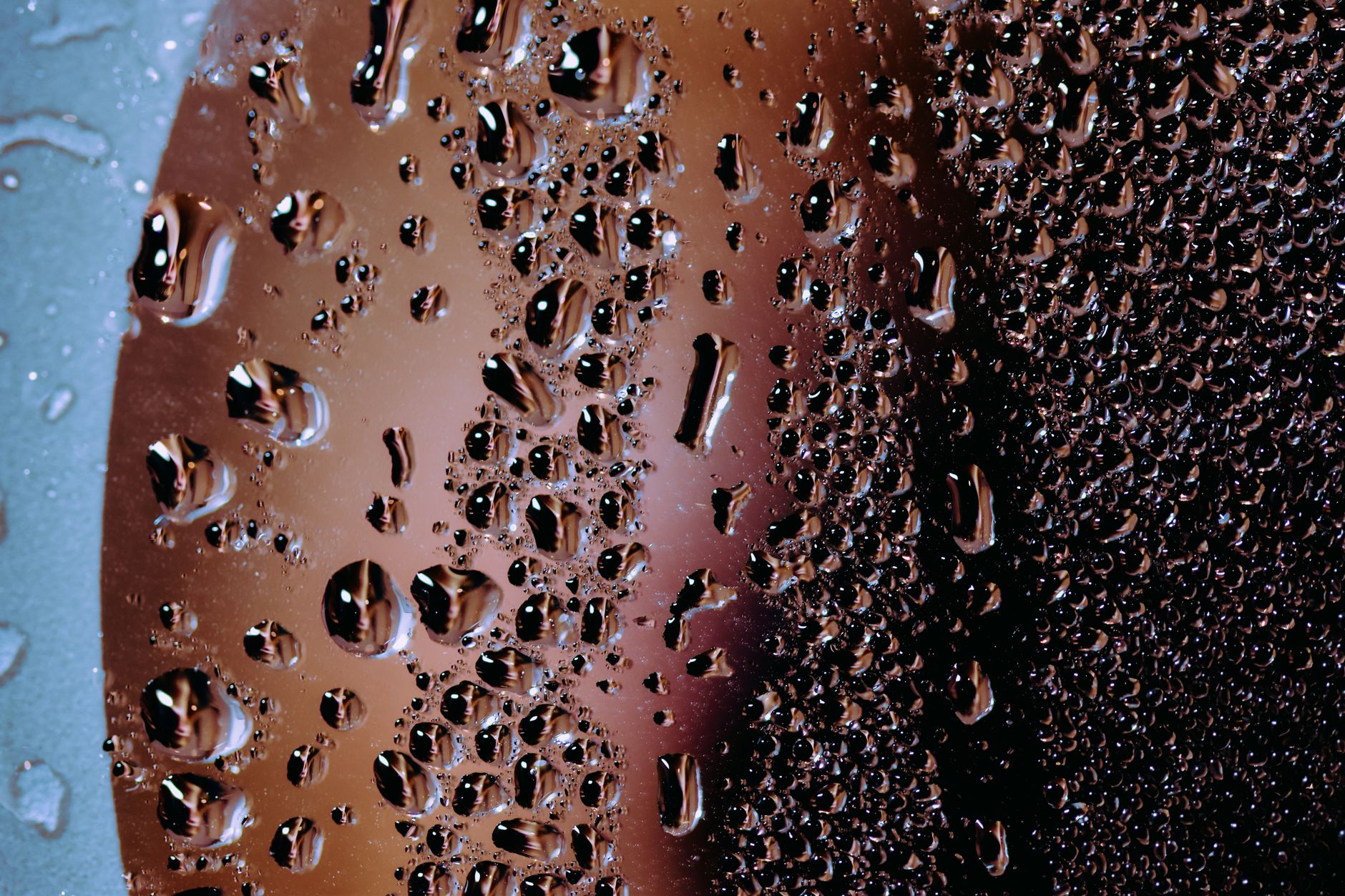 Abstract background of wet glass surface with splashed clean water drops in daylight