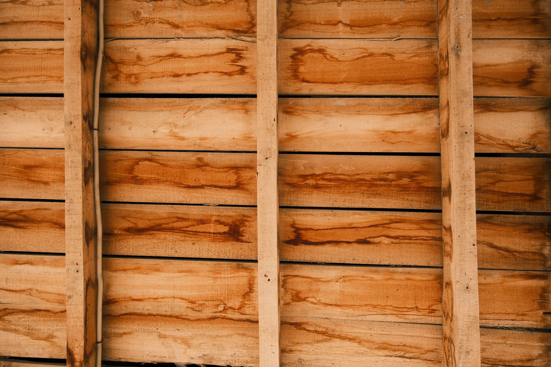 Close-up of a rustic wooden wall texture, perfect for backgrounds and design projects.