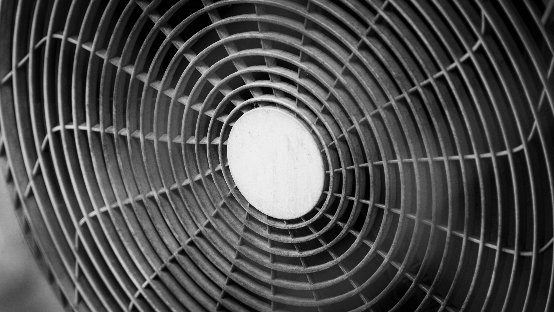 Black and white close-up of an industrial fan with a concentric design.